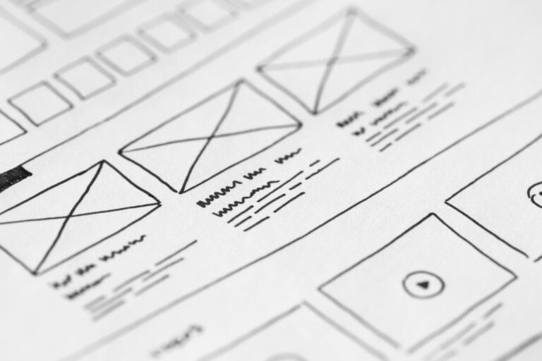 Wireframe sketch of website design on paper.